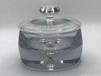 Front view of Krosno bubble glass lidded dish showing clear glass construction and bubble in base, with glass lid and knob handle.