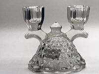 Clear glass Washington crystal candlestick with double arms and textured base showing diamond and hobnail patterning