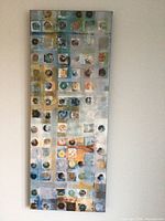 Full view of the tall rectangular canvas showing the abstract grid pattern in mixed shades of blue, yellow, orange, and black.