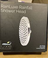 Box of Rainluxe Rainfall Shower Head with product image and brand name.
