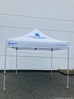 Front view of the 10x10 white pop-up tent with Autism Speaks Canada logo on canopy peak and side.