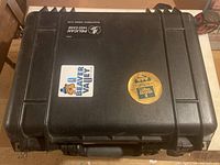 Closed Pelican 1450 hard case with stickers on top.