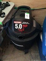 Photo of black Craftsman wet/dry vacuum showing 5.0 HP and 13 gallon capacity on label, no hose included.