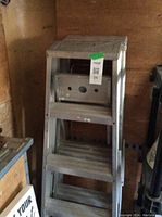 Metal step ladders stacked, showing height and step detail.