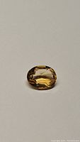 Photo of the 1.65ct oval cut natural golden citrine gemstone showing clarity and color from an angle.