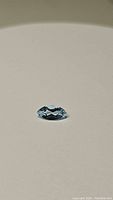 Photo showing marquis cut natural sky blue topaz with clean facets and high luster on plain background.