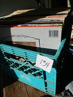 Large crate filled with a mixed lot of vintage vinyl records, stacked vertically.