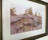 Framed landscape painting in earthy tones, showing hills and trees.