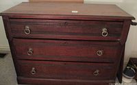 Front view of Victorian dresser showing three drawers with metal ring pulls.