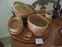 Full view of all baskets arranged on wooden table showing the variety in shapes and sizes.