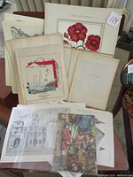 Photo showing a variety of vintage printed sheets including Japanese prints and architectural sketches.