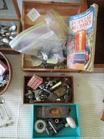 Photo showing three wooden boxes containing mix of keys, hardware, and a folded Popular Mechanics magazine