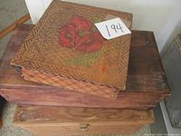 Top and angled view of the lot showing three wooden boxes stacked, with top decorative handkerchief box featuring flower painting and word 'Handkerchiefs'.