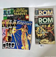 Nine Marvel comic books arranged in two groups. The first group contains several issues of The Life of Captain Marvel, Firestar, and the second group contains two ROM Spaceknight comics. The covers show distinct classic Marvel vibrant artwork.