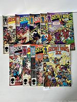 Nine Secret Wars II Marvel comics laid out, showing series and artwork on each cover.
