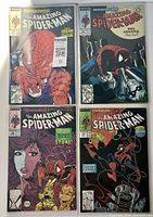 Four comics from The Amazing Spider-Man series, issues #307-310, displayed upright and bagged.