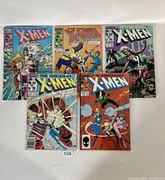 Top view of all 5 comics showing front covers, comics displayed in a semicircular pattern, showing vibrant detailed artwork and titles.