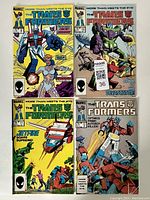 Four vintage Marvel Transformers comic books, front covers shown, featuring various issues and characters such as Starscream and Devastator.