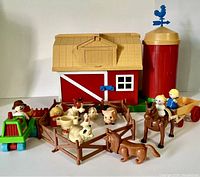 Full set of 1981 Playmates farm play set including barn, silo, fence, various farm animal figures, tractor and farmer figures arranged on a flat surface