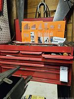 Red metal Craftsman tool chest with multiple drawers in closed position, showing some surface wear and dirt.