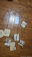 Full lot showing 7 necklaces and 3 brooches with original Edgar Berebi tags