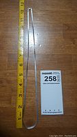 Photo showing full 12 inch length of silver chain alongside measuring tape for scale.