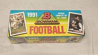 Full view of the front side of the sealed 1991 Bowman NFL Football complete set box showing brand, year, set completion indication, and player images.