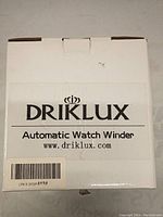 Closed white box packaging with black Driklux logo and automatic watch winder label on front