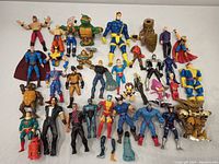 Full layout of the lot showing 31 assorted action figures with various colors and some accessories on a white background.