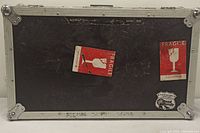 Front view of black DJ controller flight case with visible wear and two red Fragile stickers, Scratch Live label, and GoPro sticker.