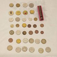 Overview of all coins laid out showing size, shape, and condition variety