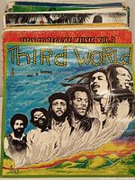 Stacked vinyl record albums displaying Third World - "Alive in Harmony" album on top, with other albums behind including This Is Reggae Music Vol. 2.