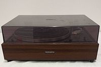 Front view of Pioneer PL-120 turntable with closed dust cover, showing wood finish and logo.
