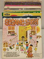 Stacked Sesame Street children's record albums showing colorful illustrated covers with classic characters and themes.