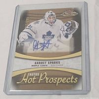Front of Garret Sparks signed hockey card showing him in goalie gear with autograph on card.