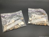 Two zipper bags filled with Canadian coins, clearly labeled on the bags as $15.00 for quarters and $20.00 for dimes.