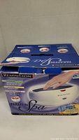 Box showing Remington Paraffin Spa with image of device and hand in wax