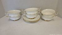 6 Royal Albert Val D'Or two-handled white soup bowls stacked in pairs with 6 matching white saucers