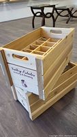 Two stacked wooden wine crates showing the 'Valley Estates Vintning & Brewing' logo on the side.