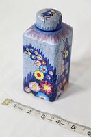 Front angle view showing the rectangular shape and floral pattern on the body of the tea caddy along with measuring tape indicating approx. 4.5 inches tall.