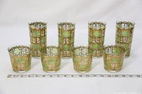 Photo showing 8 vintage glassware pieces with gold accents and greenish decorative panels in two sizes.