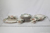 Full view of the china set showing plates, serving dishes, sugar bowl, creamer and gravy boat