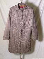 Front view of light mauve padded winter coat with zippered pockets and mandarin collar