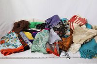 Full view of assorted scarves in various colors, materials, and patterns
