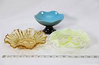 Three vintage specialty serving dishes on white background with measuring tape in front showing size.