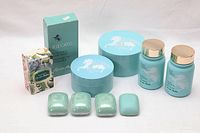 Full set of Elizabeth Arden Blue Grass items including boxed soap, soap bars, milk bath bottles, and round boxes.