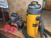 Full lot: yellow vacuum, black compressor, red coiled hose