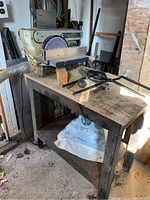 Mastercraft belt and disc sander mounted on a metal table with wooden top. Shows dust and signs of workshop use.