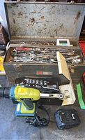 Overall lot showing Radley cordless drill, Craftsman toolbox filled with hand tools, charger, and loose batteries and sockets