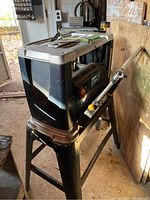 Front perspective showing planer mounted on metal stand